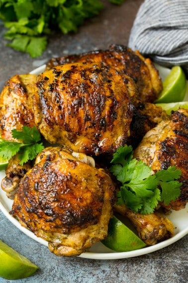 A plate of grilled chicken coated in jerk chicken marinade.