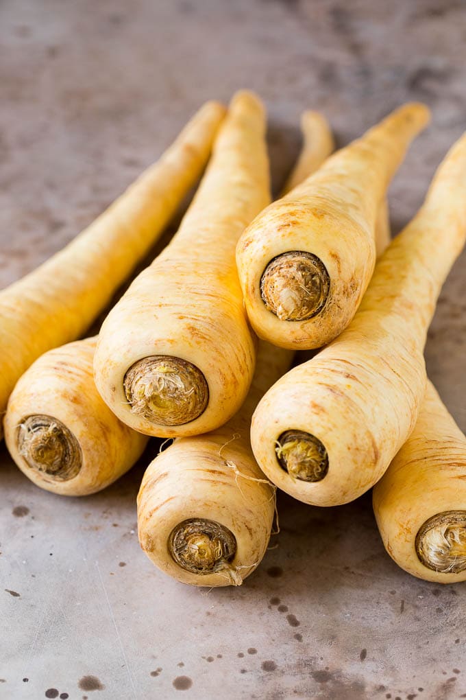These roasted parsnips are coated in garlic, olive oil and herbs, then cooked in the oven until golden brown and tender. A quick and easy side dish option that pairs perfectly with chicken, beef and pork. Whole raw parsnips.