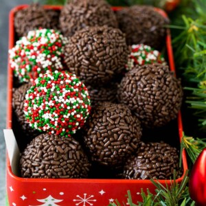 A tin of rum balls coated in holiday sprinkles.