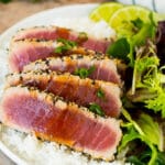 Seared ahi tuna served with rice and salad.