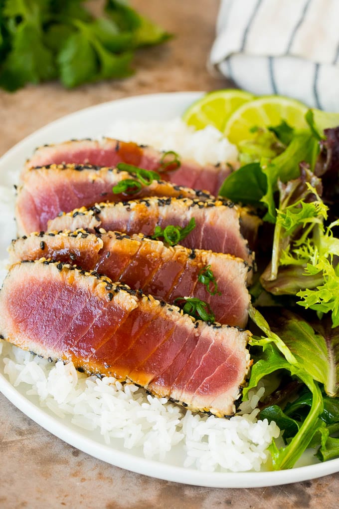 Seared ahi tuna served with rice and salad.