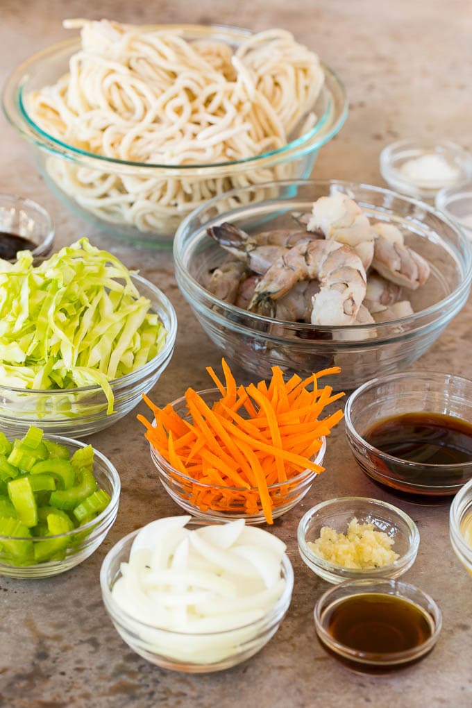 Bowls of ingredients including shrimp, noodles and vegetables.