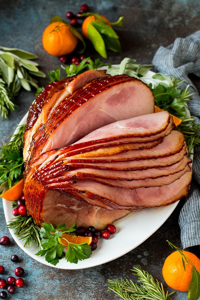 Spiral ham coated in a brown sugar glaze on a platter.