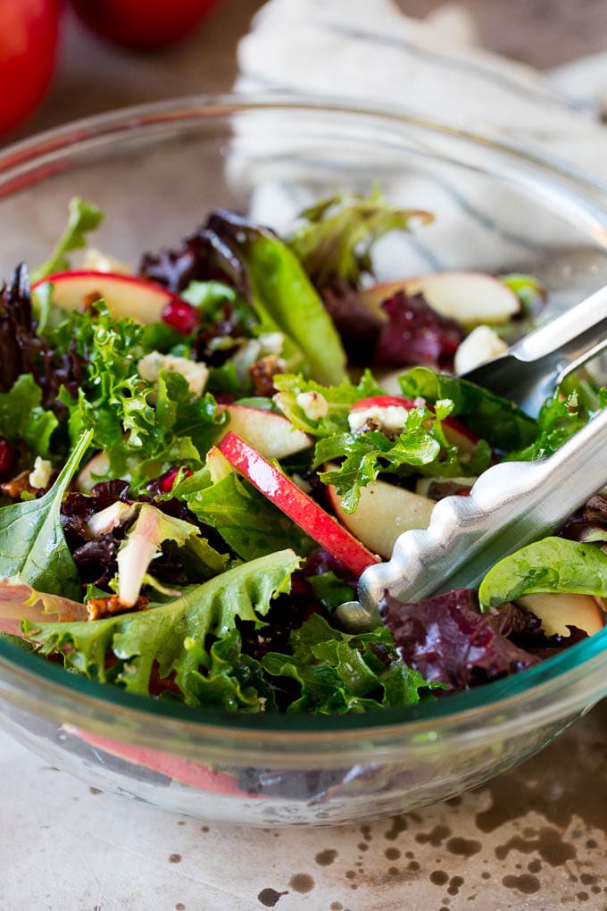 Tongs serving up a portion of Thanksgiving salad.