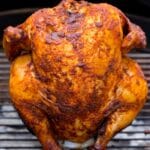 Beer can chicken on a grill.