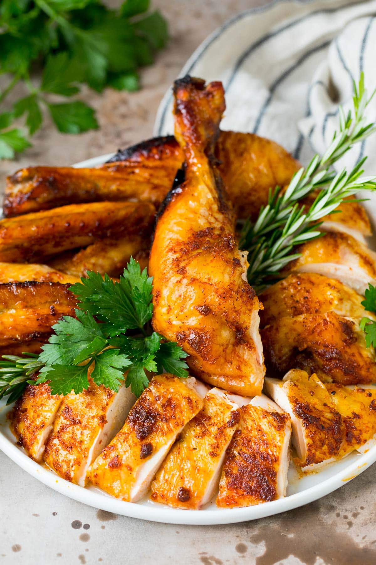 Sliced beer can chicken with fresh herbs.