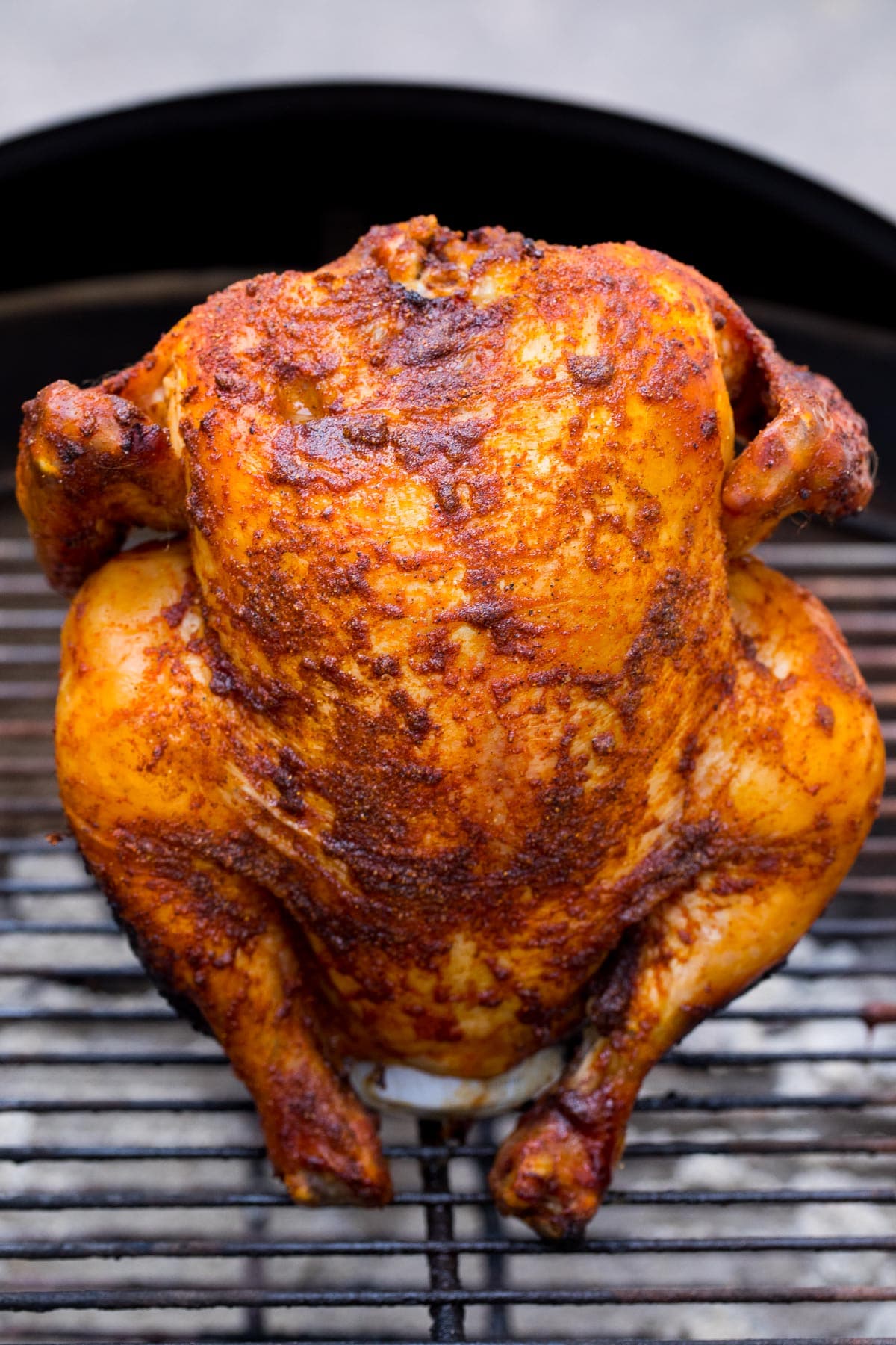 Beer can chicken on a grill.