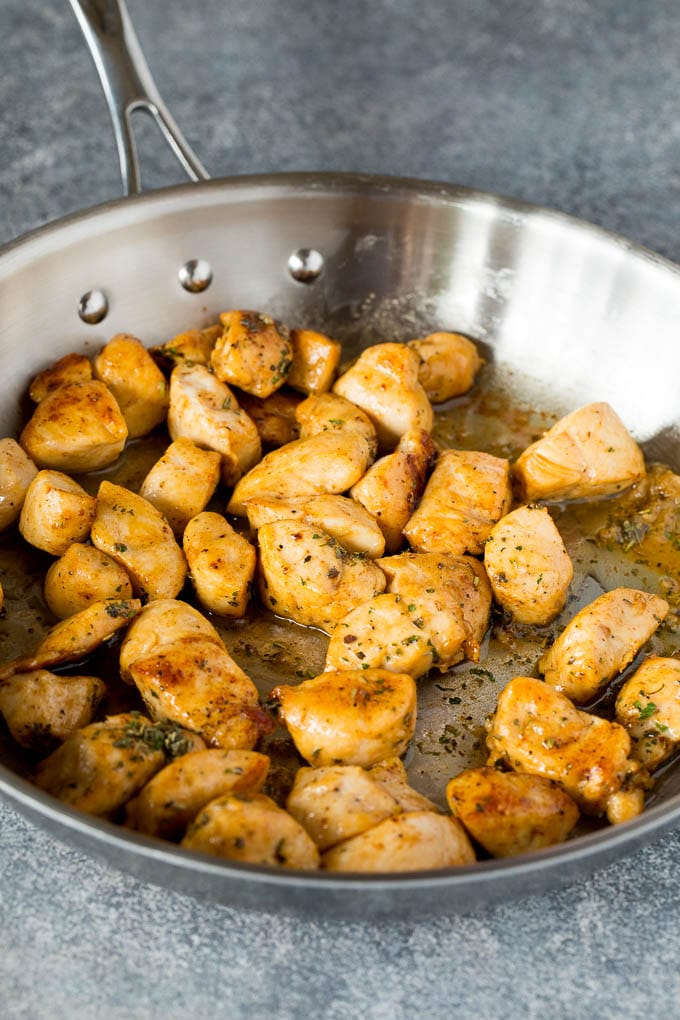 Cooked diced chicken in a skillet.