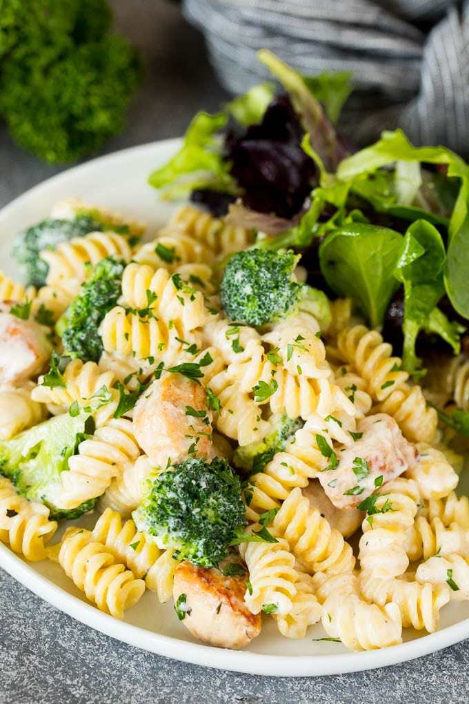 Chicken broccoli Alfredo pasta served with salad.