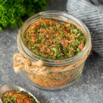 A jar of chicken seasoning made with dried herbs and spices.