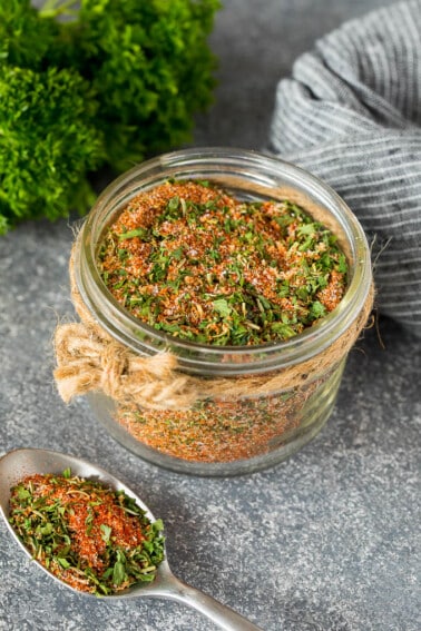 A jar of chicken seasoning made with dried herbs and spices.