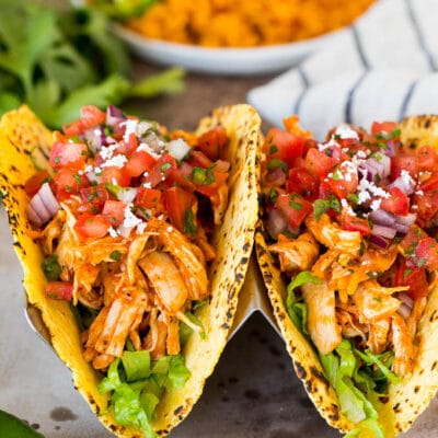 Chicken tinga tacos with lettuce and pico de gallo.