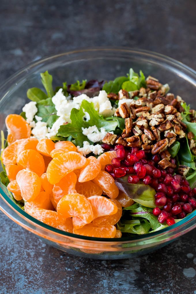 Greens topped with fruit, feta cheese and candied pecans.