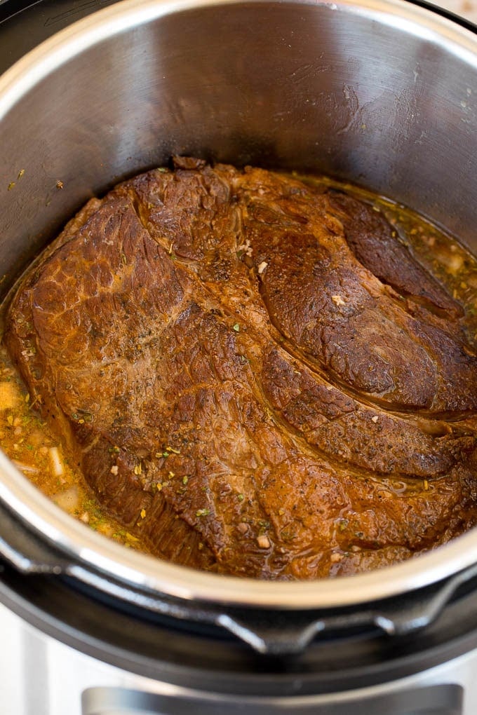 A seared chuck roast in an Instant Pot.