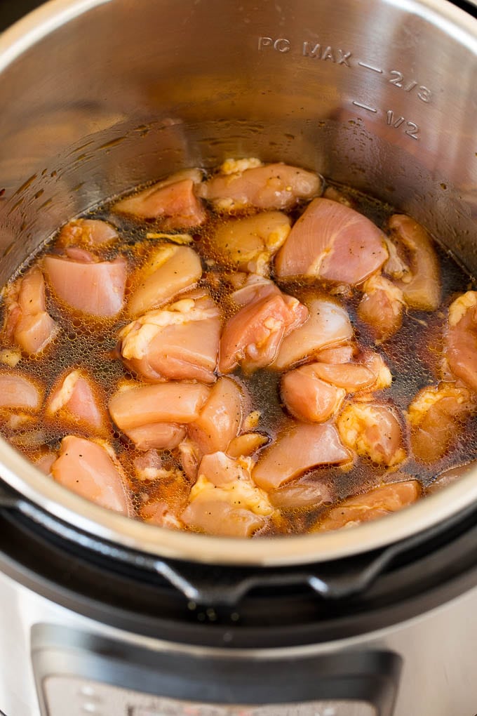 Chicken and sauce in a pressure cooker.