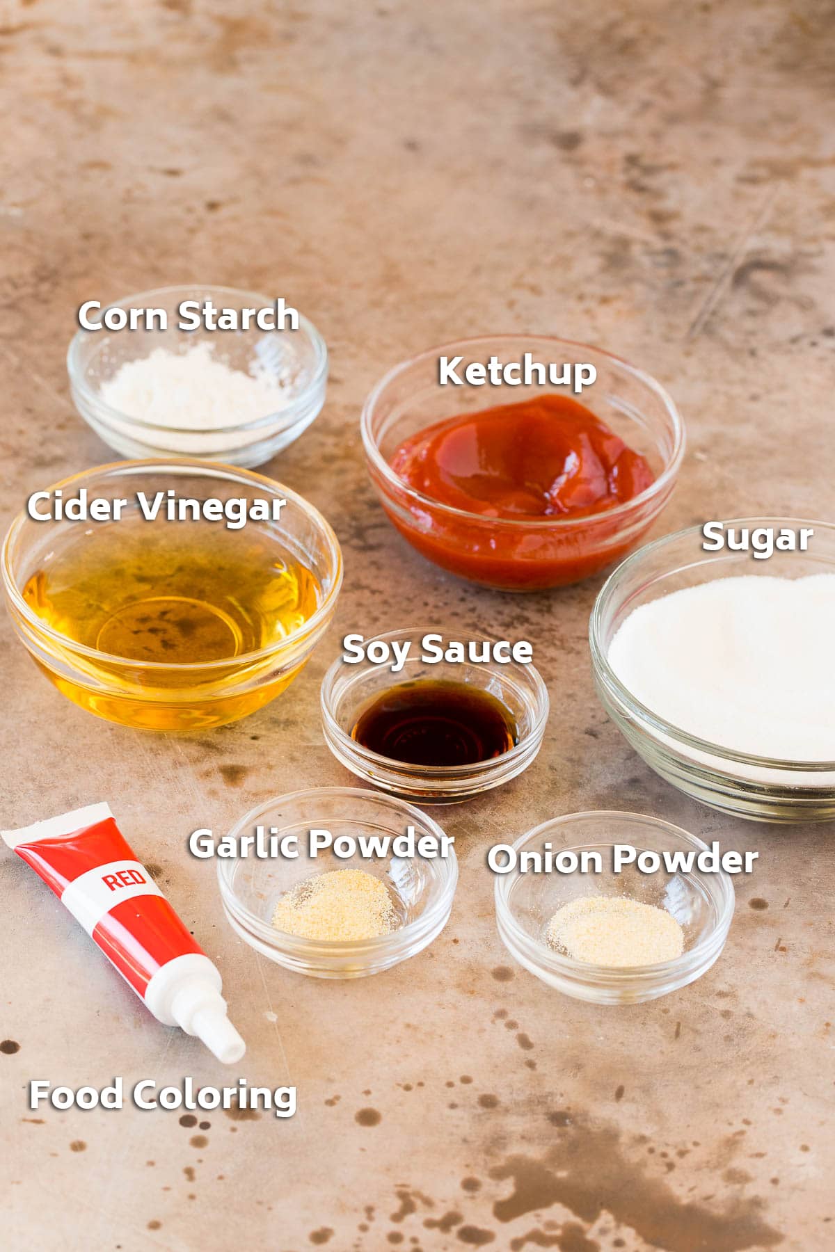 Ingredients in bowls including sugar, vinegar, soy sauce and spices.