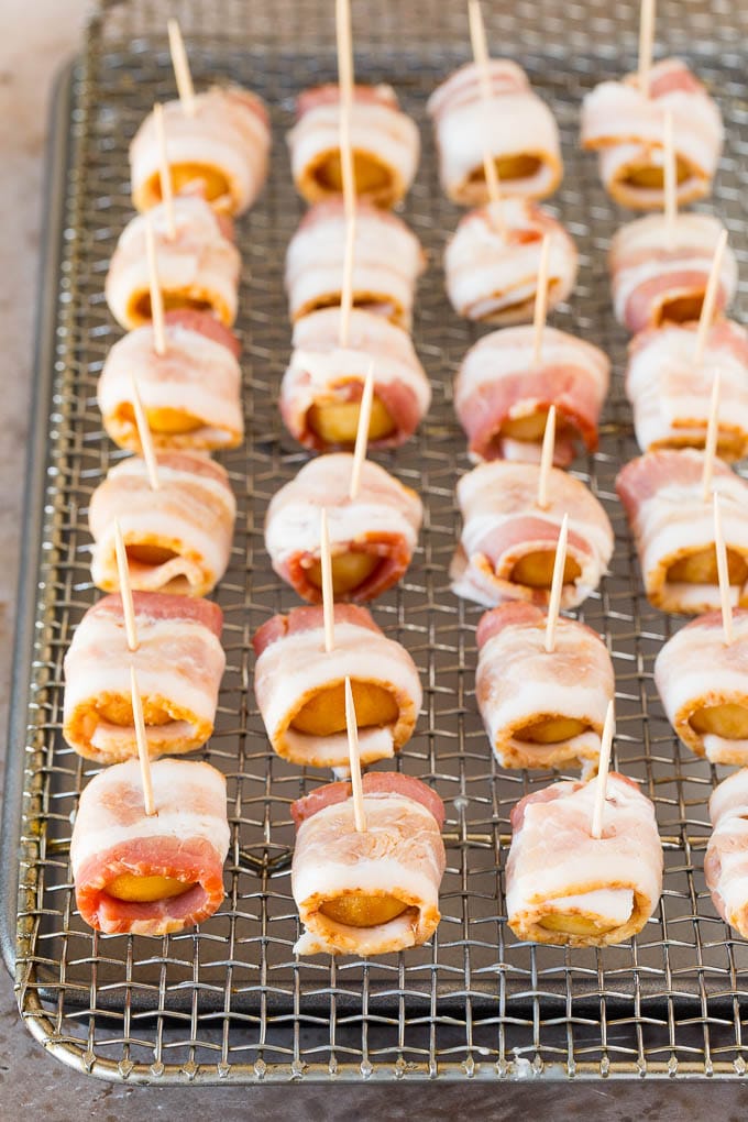 Water chestnuts covered in bacon and secured with a toothpick.