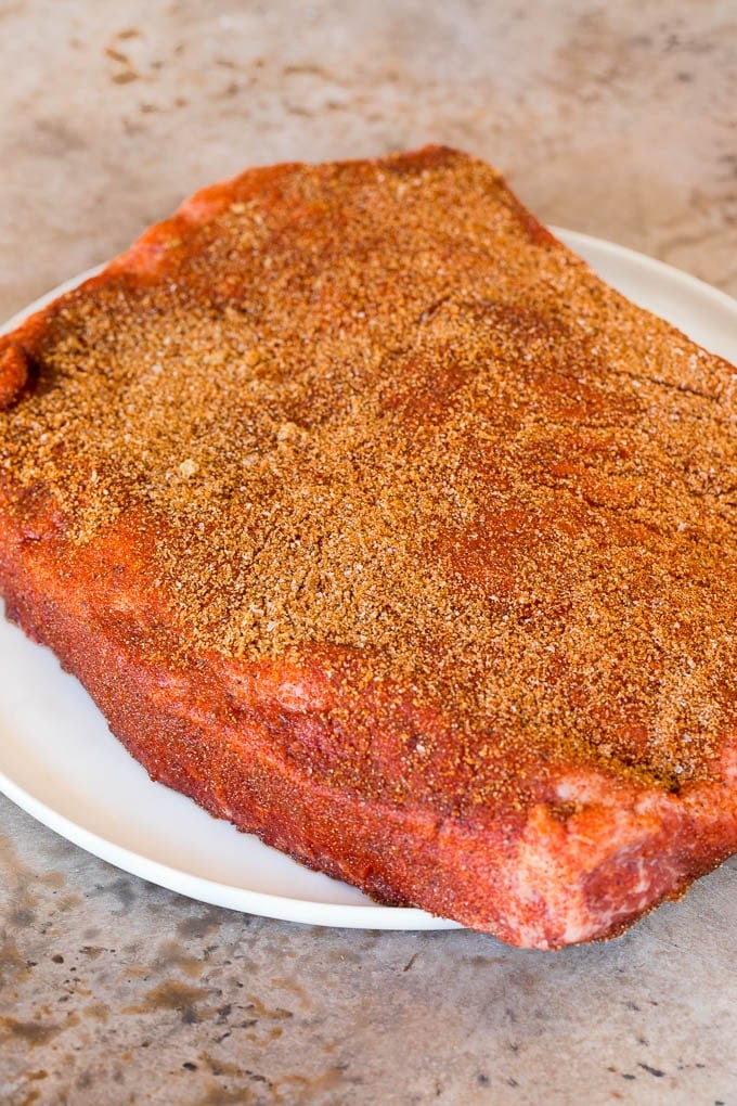 A brisket coated in BBQ spice rub.