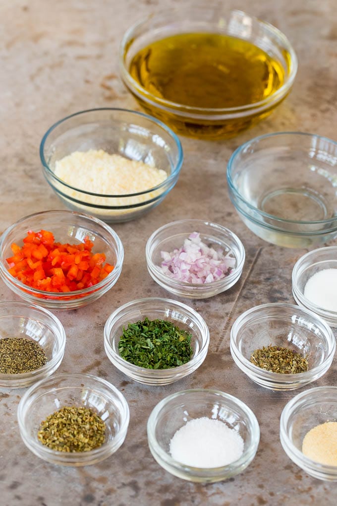 Bowls of herbs, seasonings and olive oil.