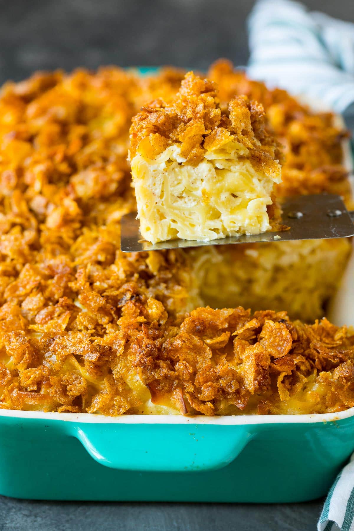 A spatula serving up a portion of noodle kugel.