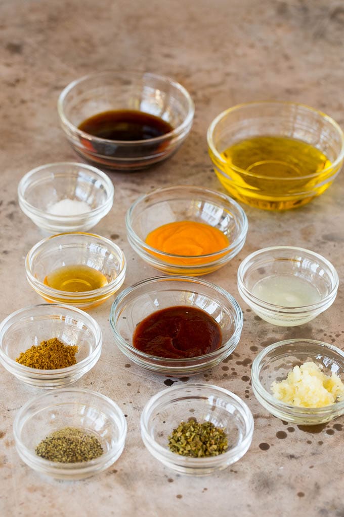 Bowls of chicken marinade ingredients including olive oil, soy sauce and spices.