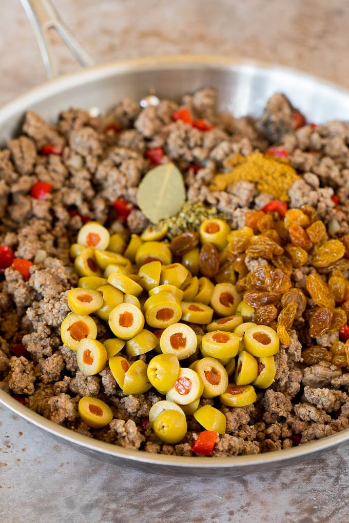 Cooked ground beef with olives, raisins and spices.