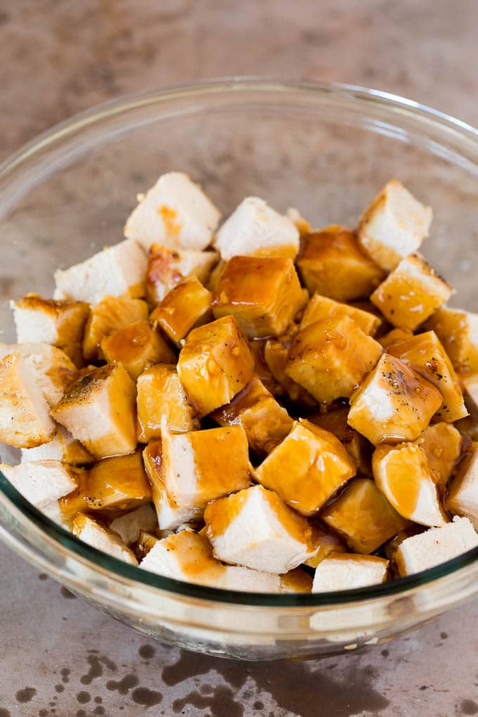 Diced chicken in a bowl with teriyaki sauce.