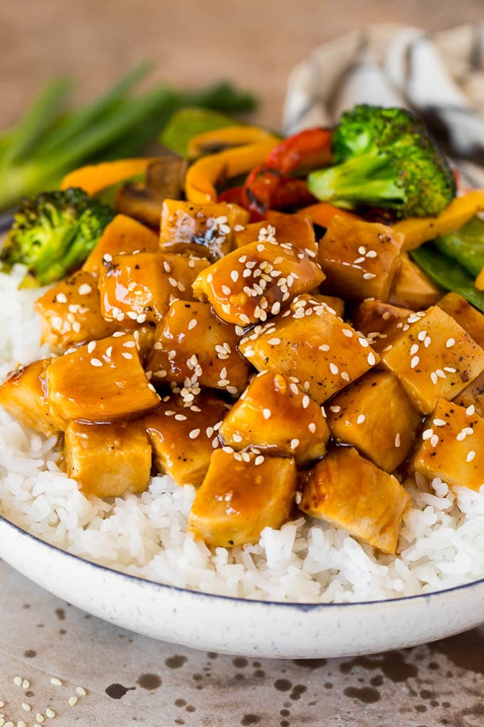 Teriyaki sauce on diced chicken served with rice and vegetables.