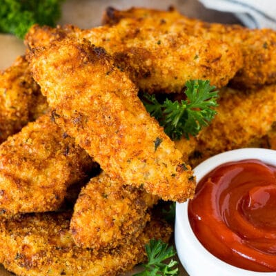 A plate of air fryer chicken tenders served with ketchup.