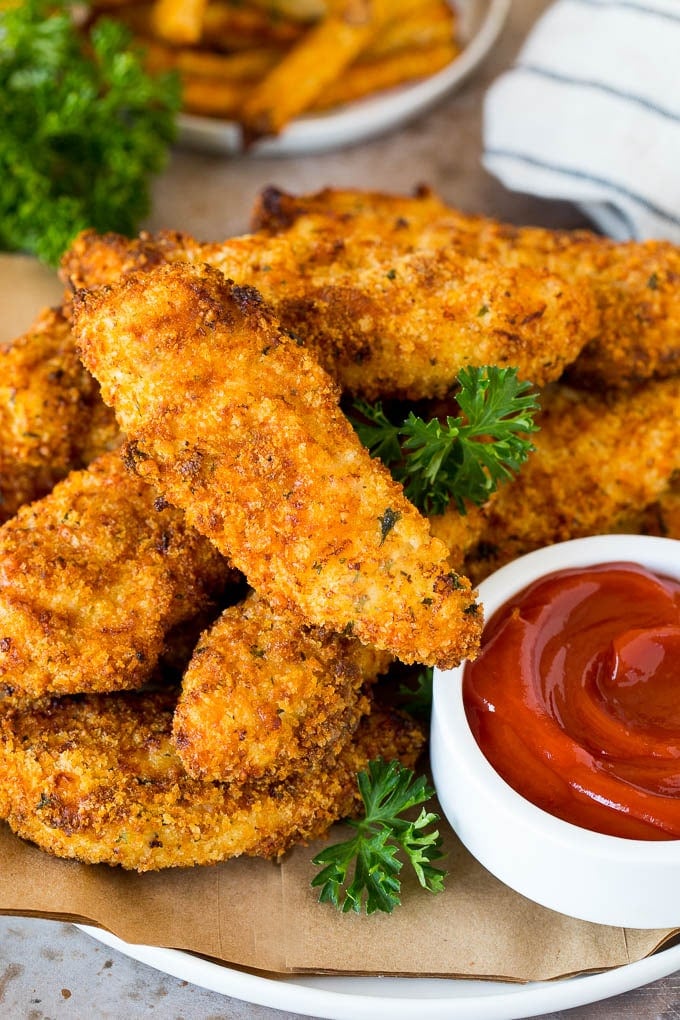 A plate of air fryer chicken tenders served with ketchup.