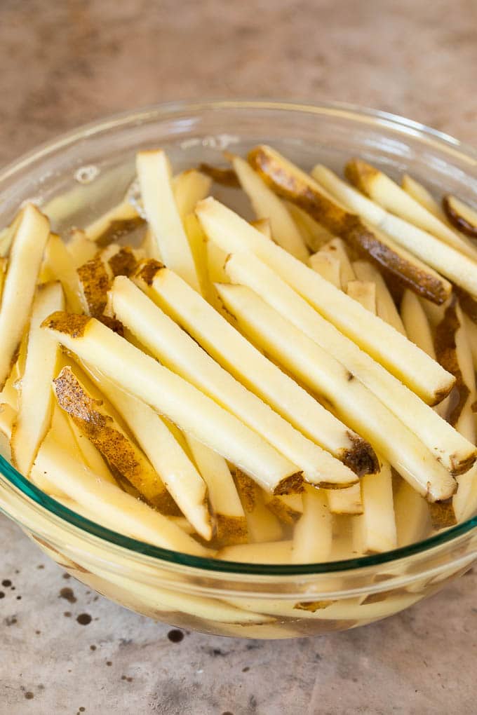 Cut potatoes in a bowl of water.