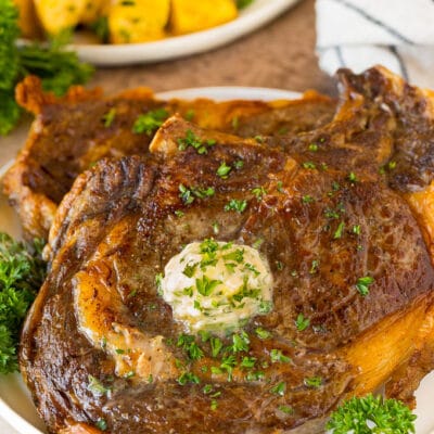 Air Fryer steak with garlic butter and herbs on top.