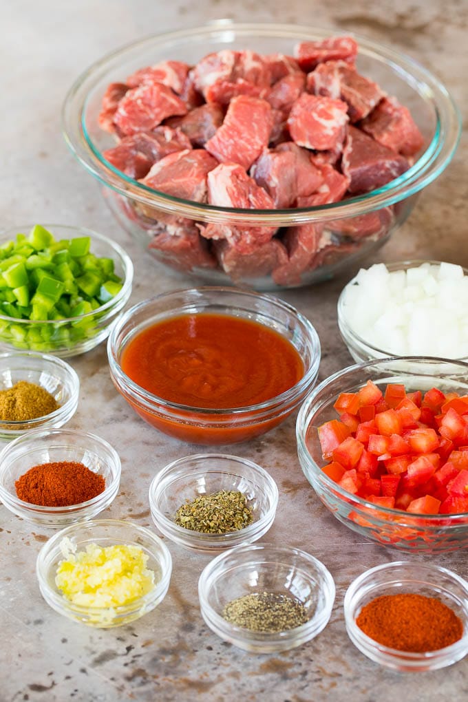 Bowls of ingredients including cubed beef, vegetables and seasonings.