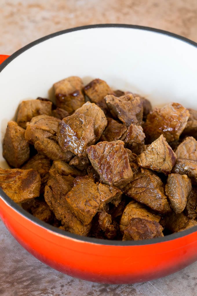 Seared beef chunks in a pot.