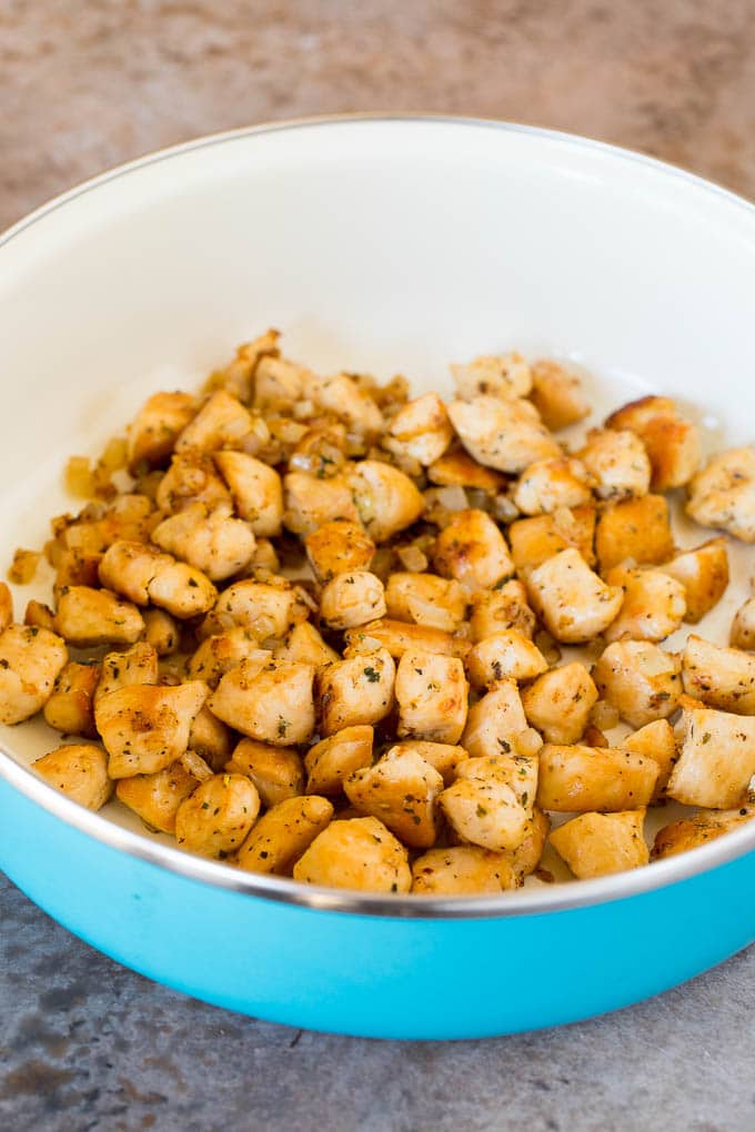 Sauteed chicken in a pan.