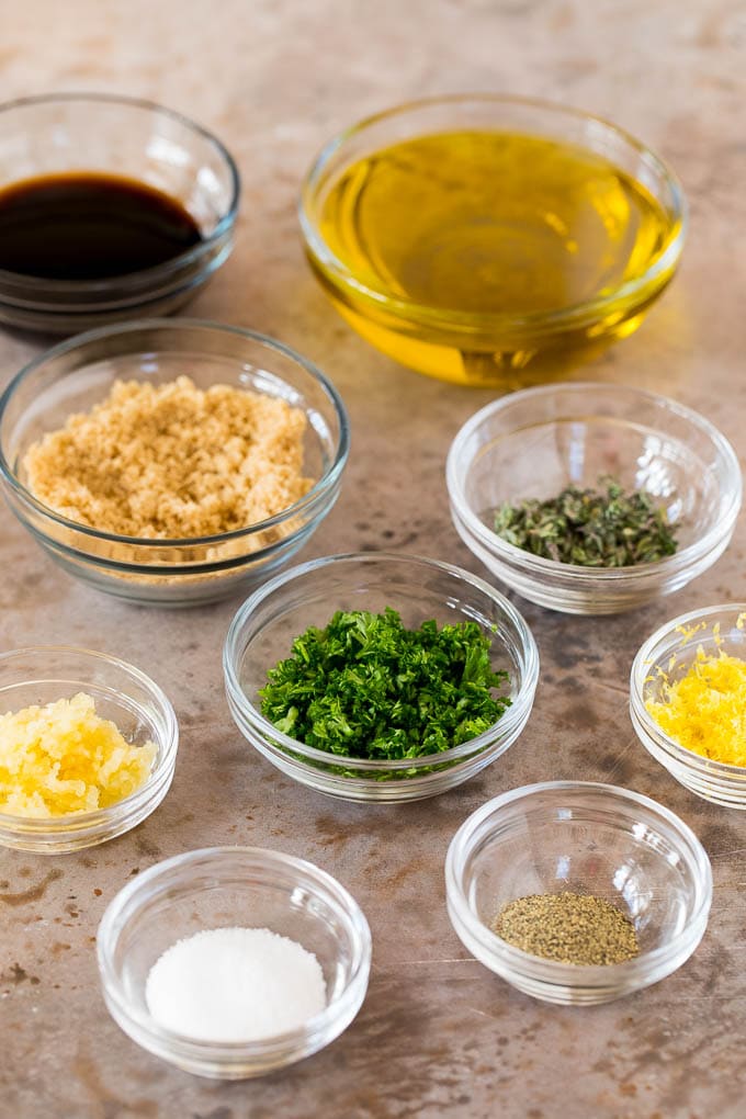 Bowls of ingredients including garlic, herbs, olive oil and soy sauce.