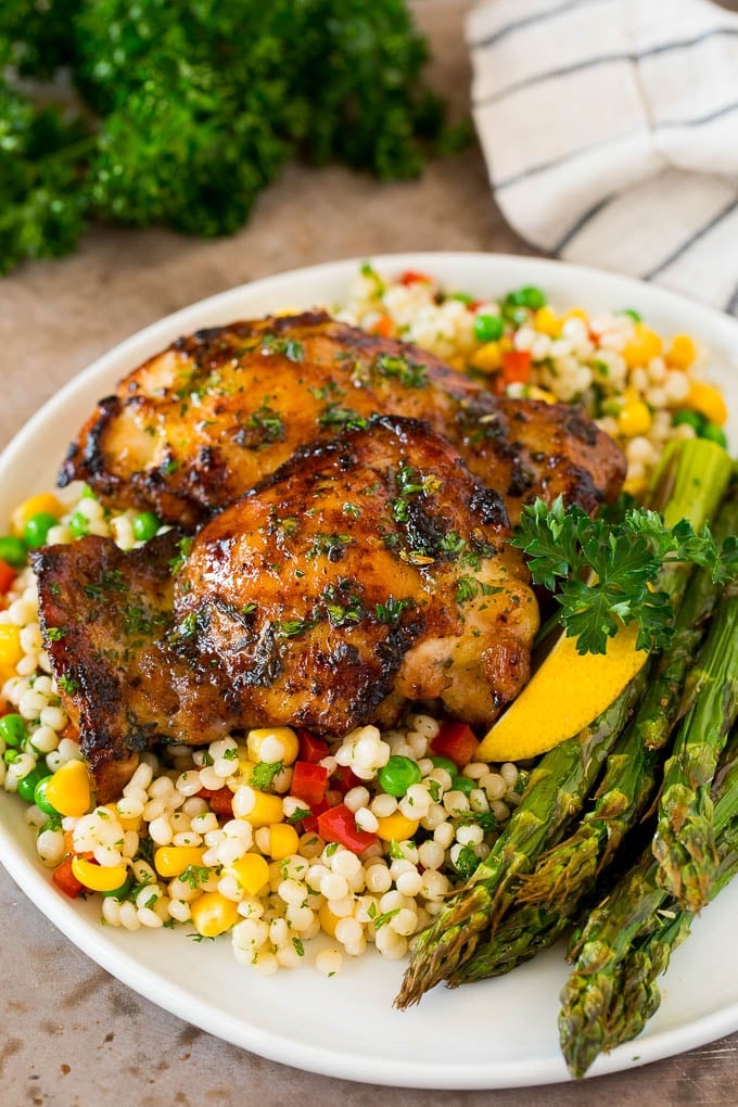 Marinated chicken thighs served with couscous and asparagus.