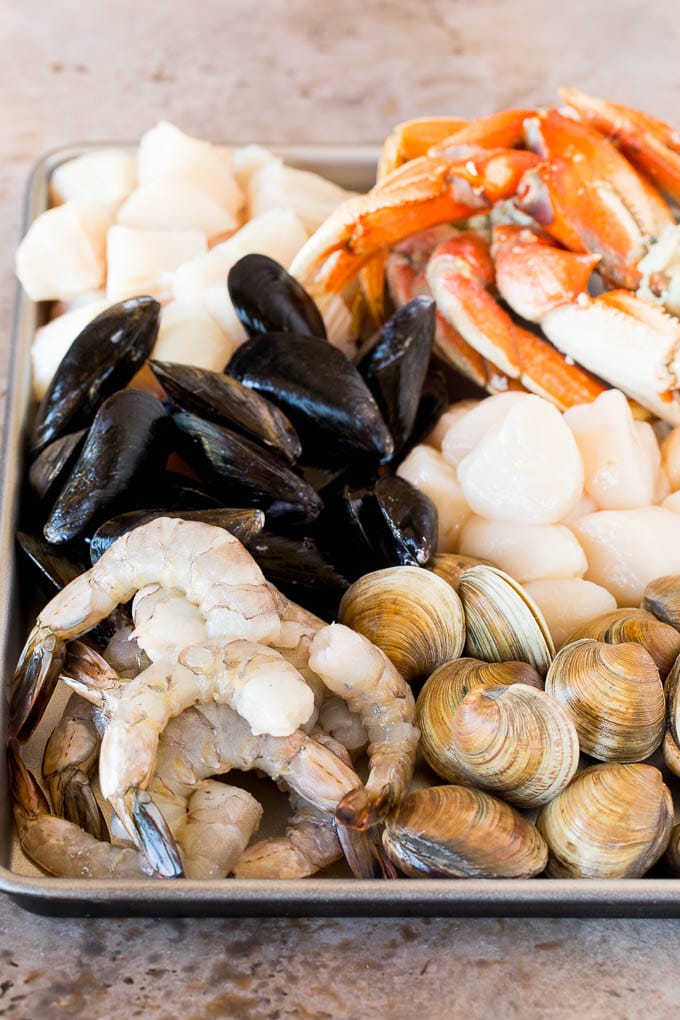 A sheet pan of assorted seafood and shellfish.