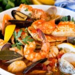 A large bowl of cioppino with crab, shrimp and shellfish.