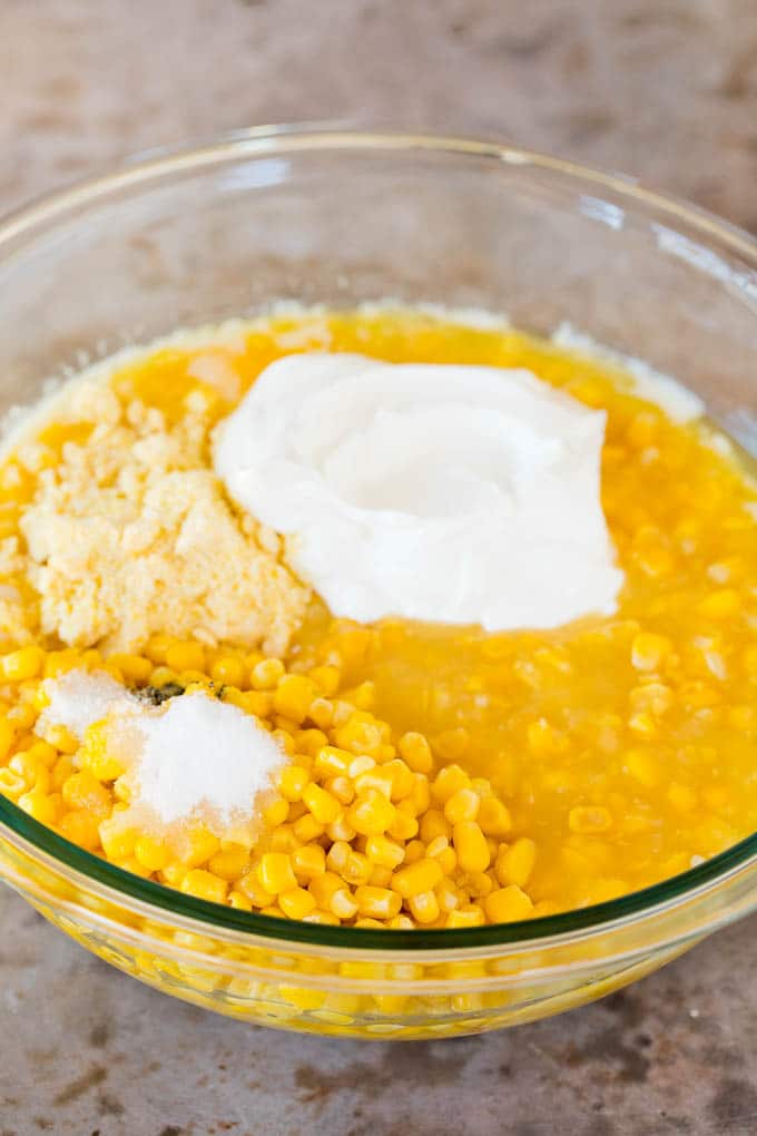 Corn, sour cream, corn muffin mix and sugar in a bowl.