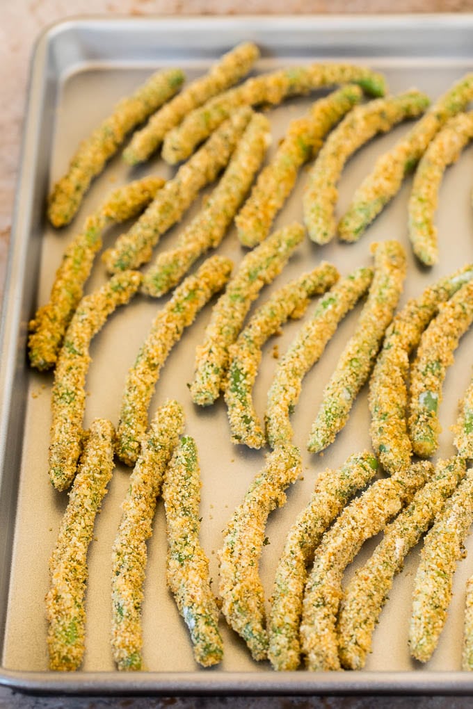 Breaded green beans on a sheet pan.