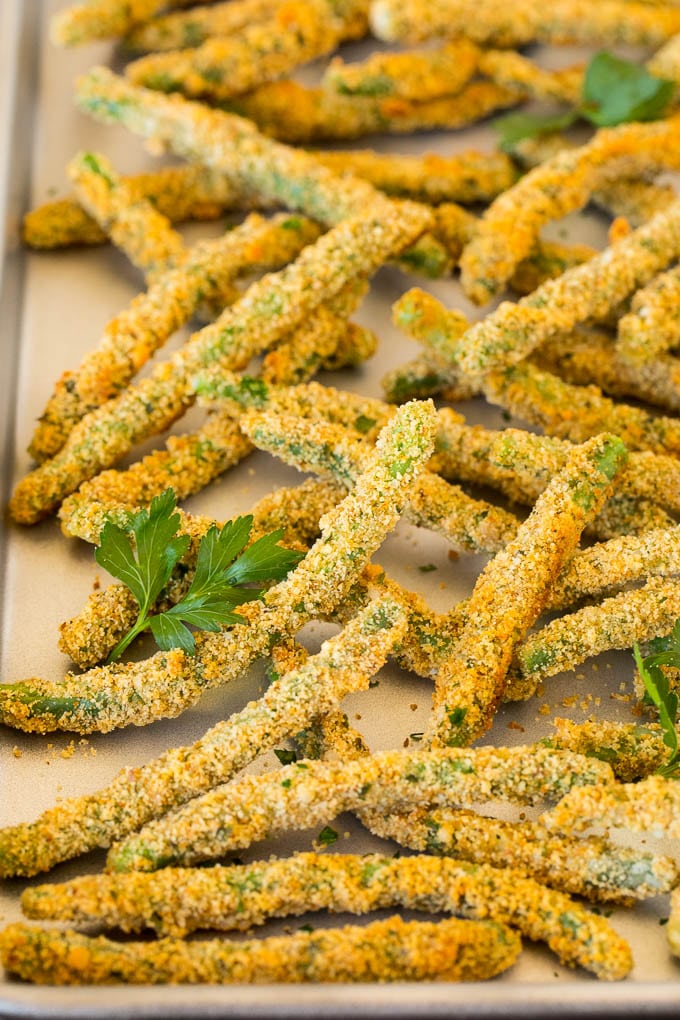 A pan of green bean fries garnished with parsley.