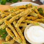 A plate of green bean fries served with parsley and ranch.