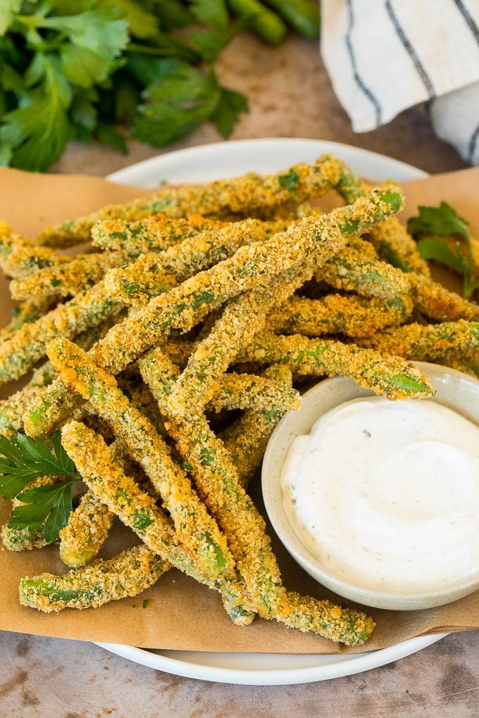 A plate of green bean fries served with parsley and ranch.