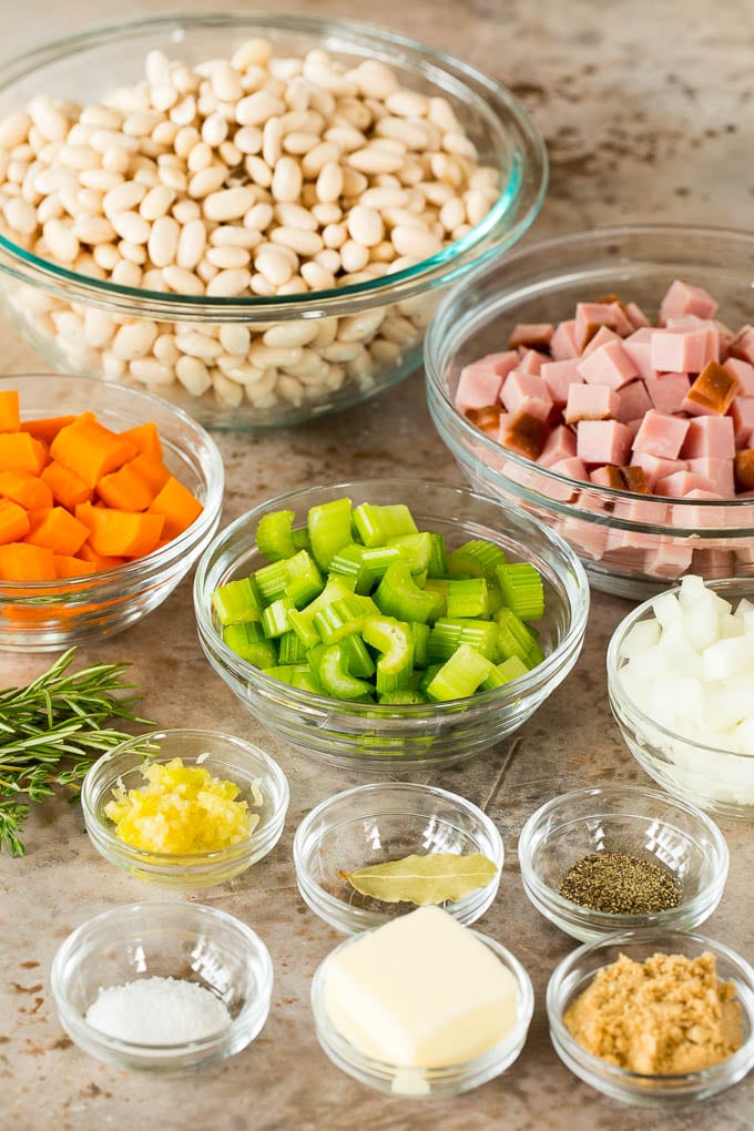 Bowls of ingredients such as ham, vegetables and seasonings.