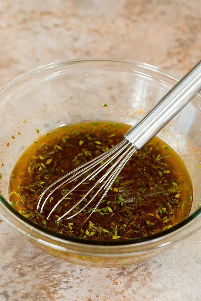 A bowl of olive oil mixed with soy sauce, garlic and seasonings.