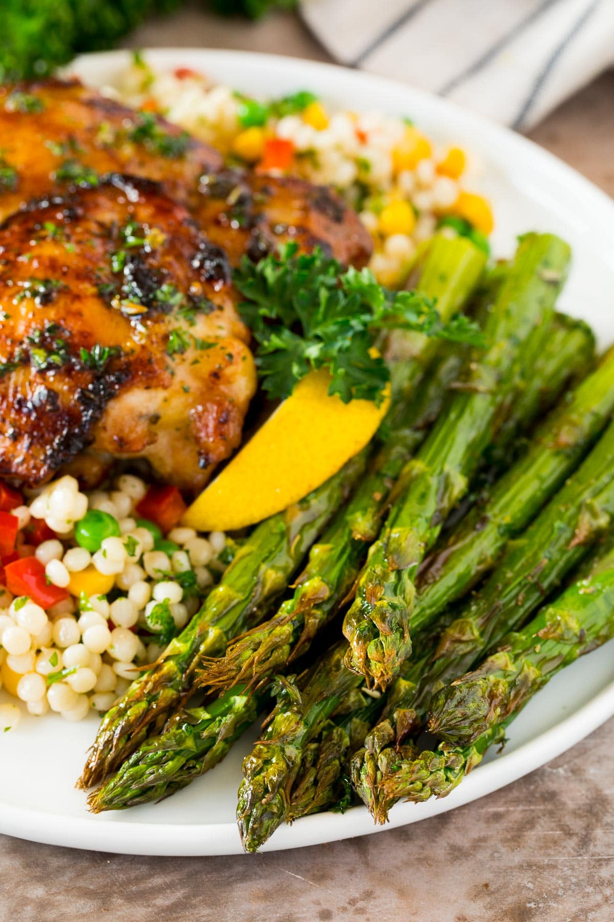 Air fryer asparagus served with chicken and couscous.