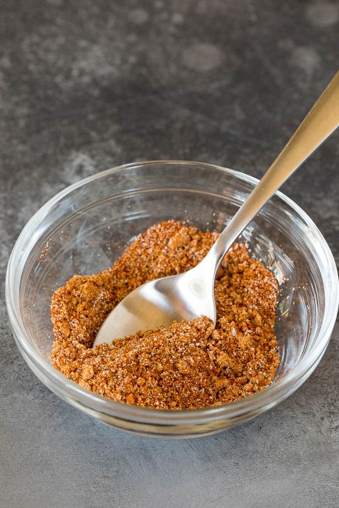 A spice blend in a bowl with a spoon.