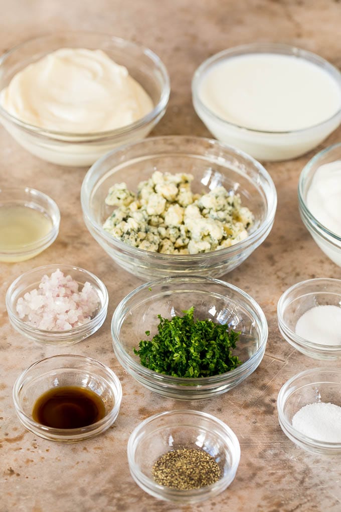 Bowls of sour cream, buttermilk, mayonnaise, blue cheese and seasonings.