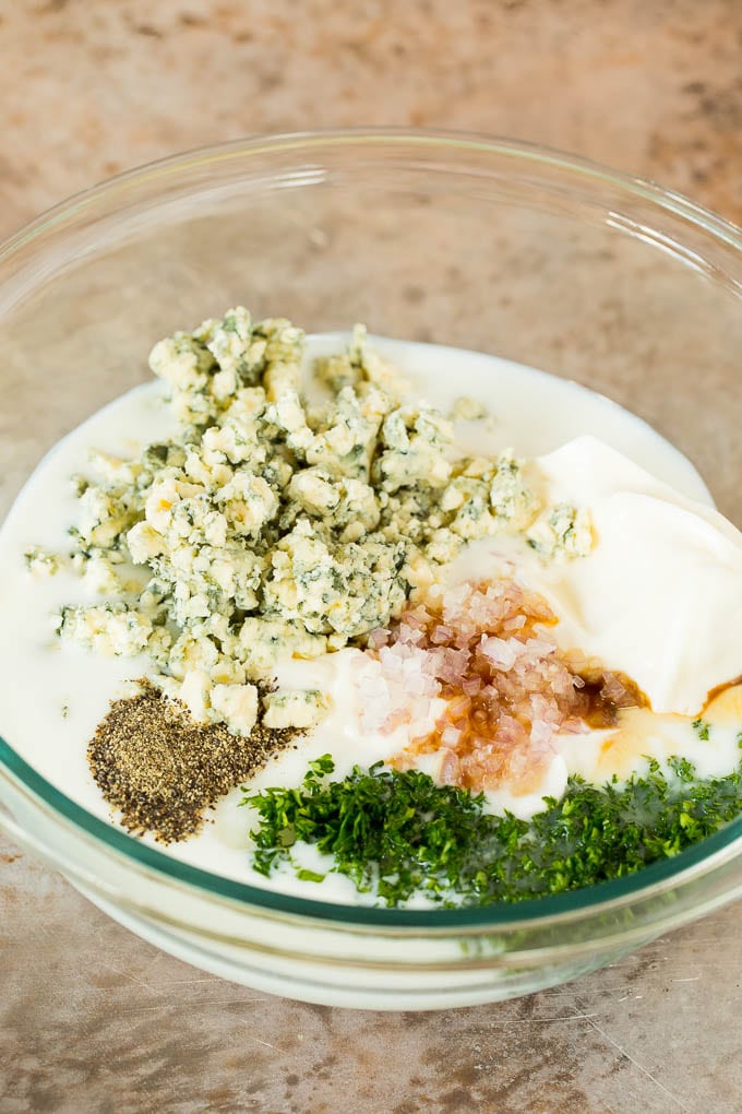 Dairy products, spices and parsley in a bowl.